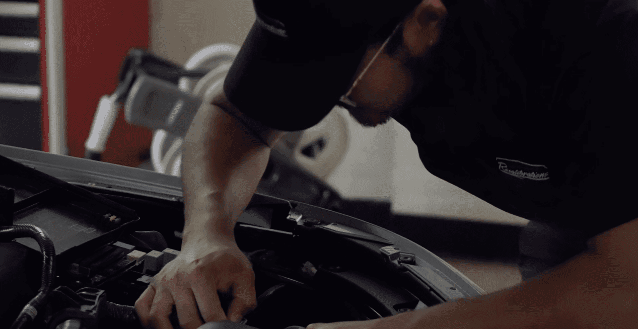 Technician servicing a vehicle at Express Diagnostics